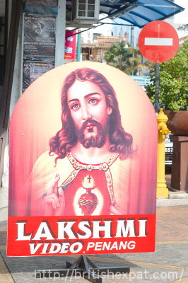 Sign advertising the Lakshmi video shop in Penang, with a rather incongruous Sacred Heart Jesus