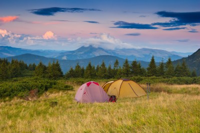 Tents on a hillside in Ukraine's Carpathian Mountains at sunset