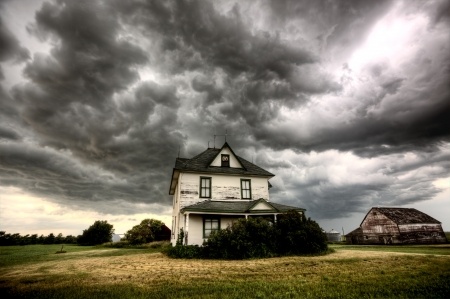 A lonely house under a stormy sky