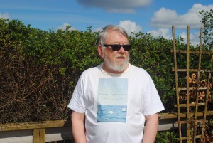 Author chilling out with his book's front cover on T-shirt