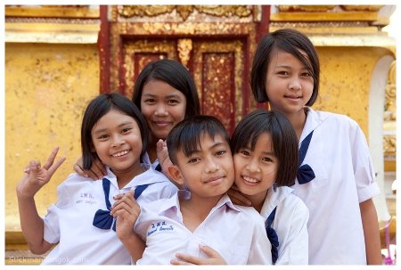 Thai schoolchildren in uniform outside a wat (Buddhist temple)