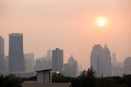 Smoggy Bangkok skyline with the sun struggling to break through