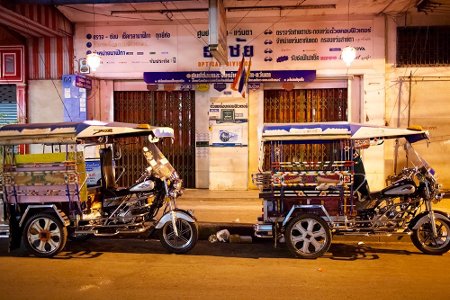 Two tuk-tuks outside a shopfront in Bangkok