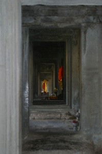 Saffron-robed statues in the galleries at Angkor Wat