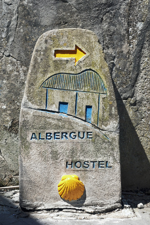 Sign pointing to a pilgrims' hostel in Spain